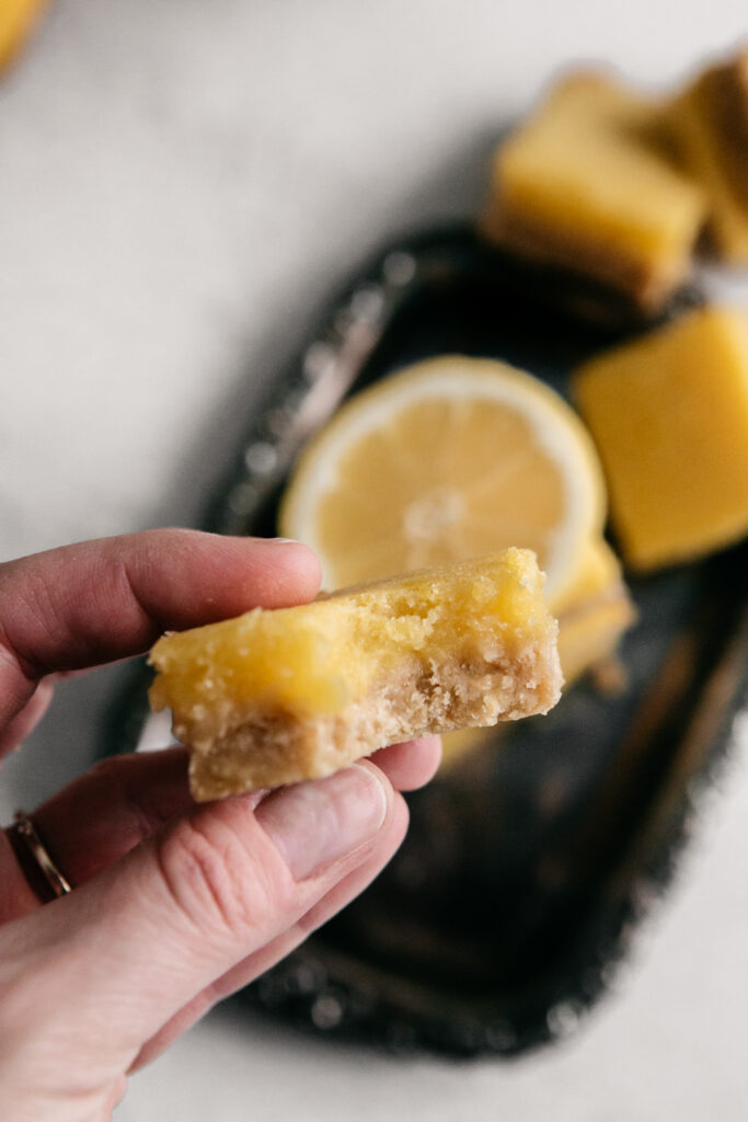 a lemon bar with a bite out 