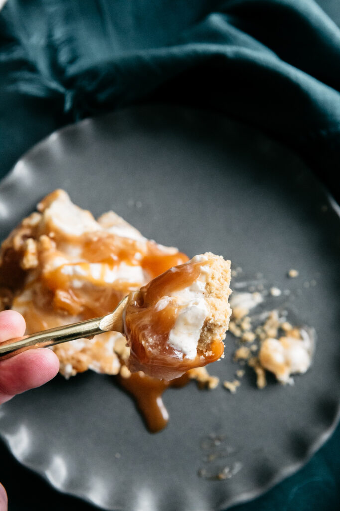 a bite of cheesecake on a fork 