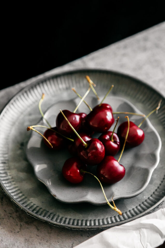 cherries on a grey plate 