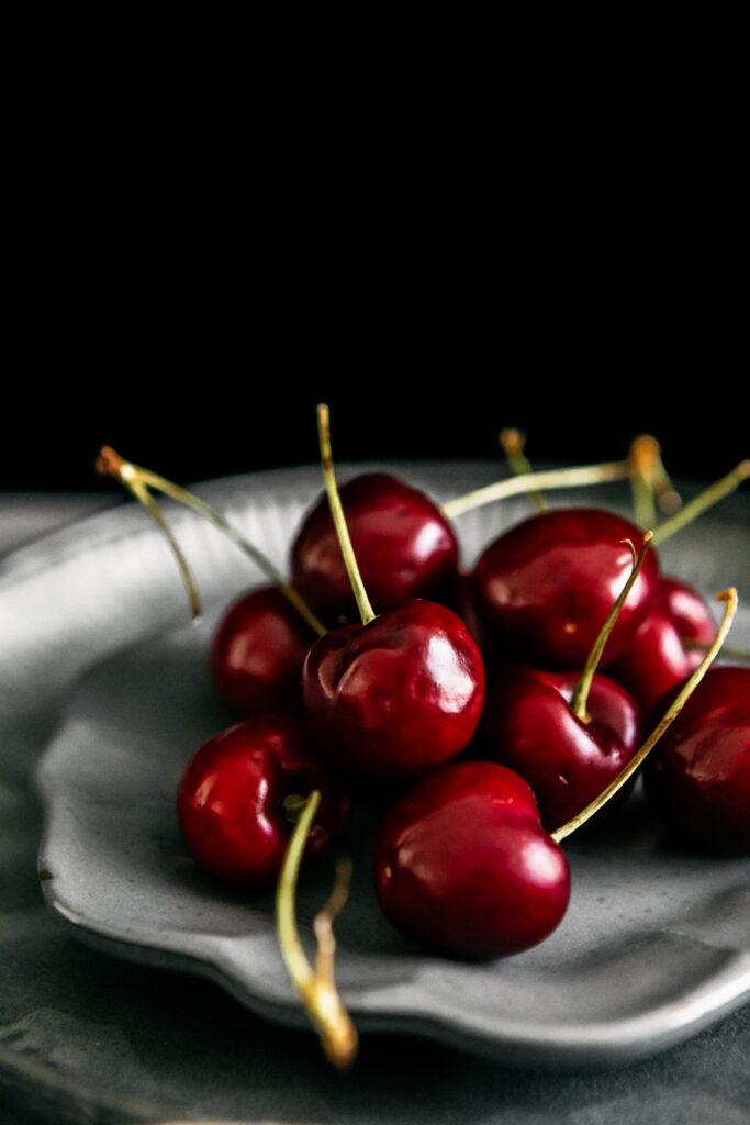 cherries on a grey plate 