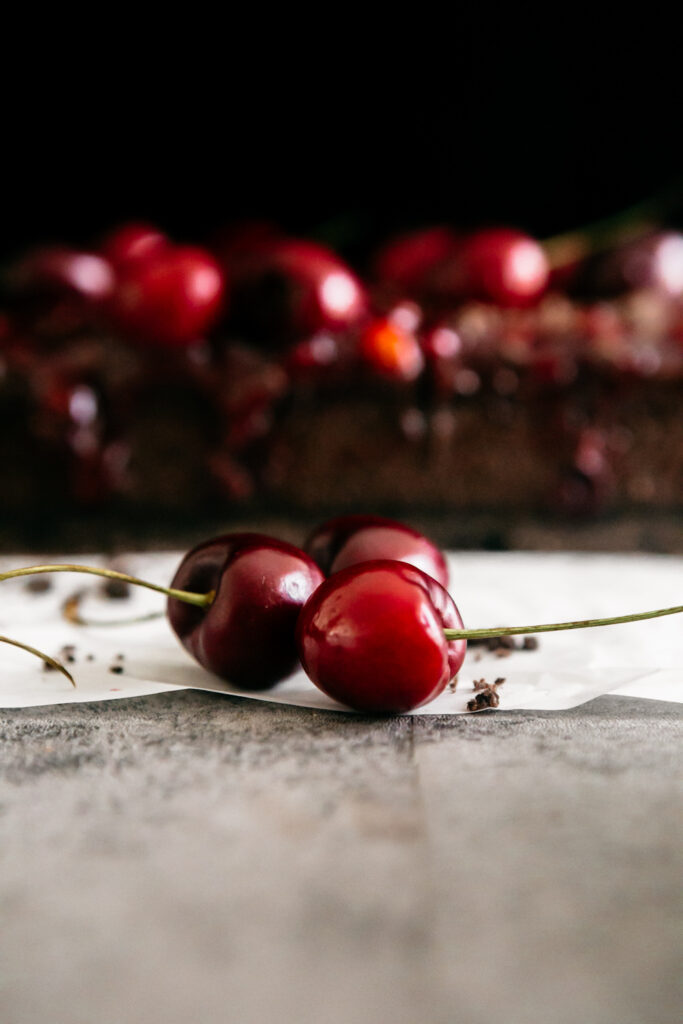 cherries in front of cheesecake bars 