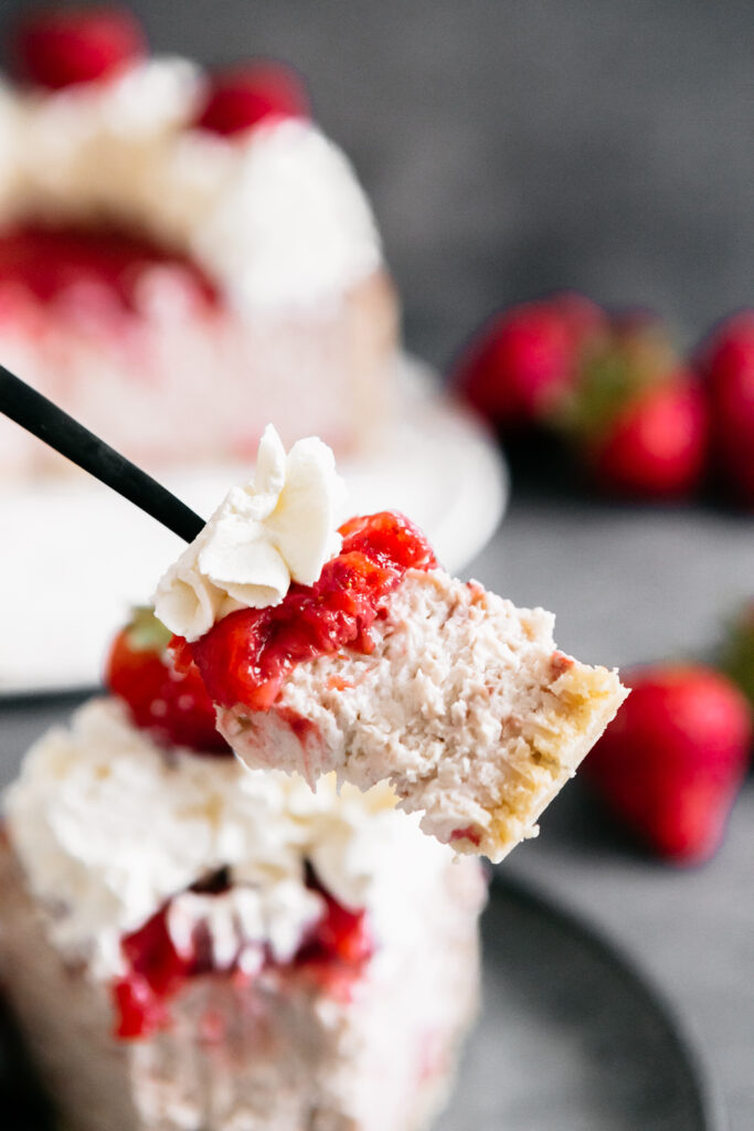 a bite of cheesecake on a fork 