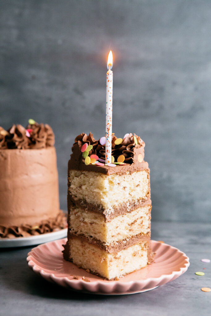 slice of cake with candle in it 